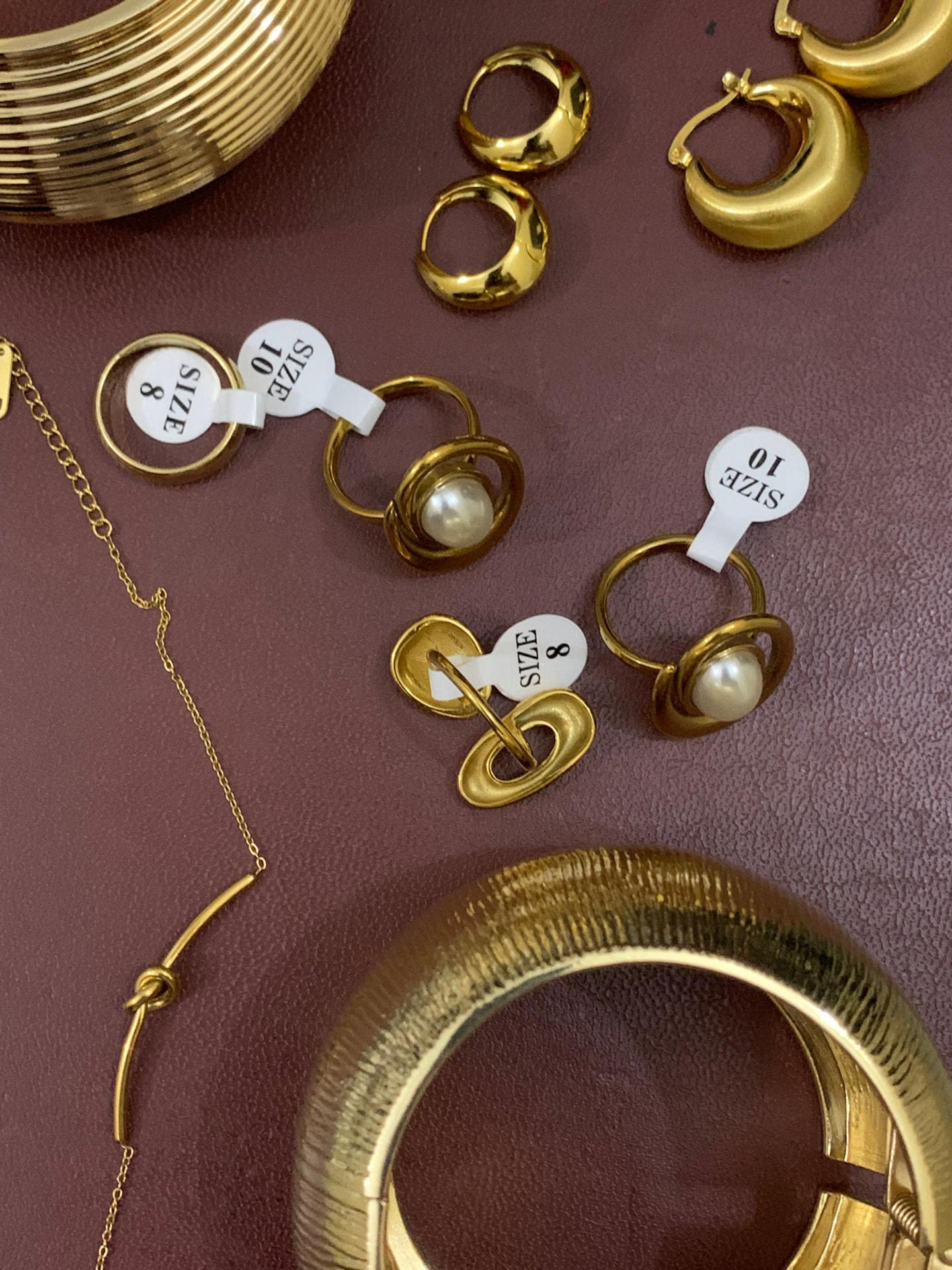 Gold hoops, rings and bangles laid out together